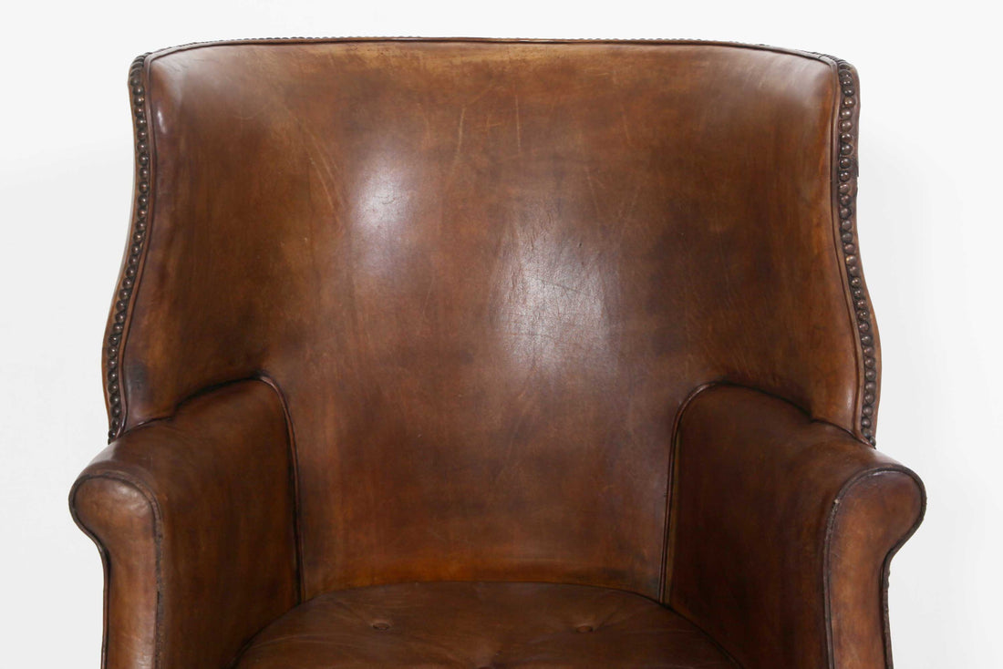 Antica e originale poltrona inglese barrel back marrone cognac